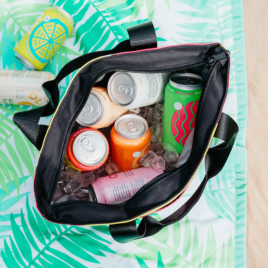 Best pool bag packed with iced drinks on a beach blanket