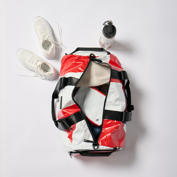 Weekender travel beach bag packed with sneakers and a water bottle